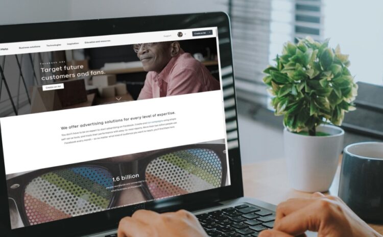 Marketer reviewing digital advertising website on a laptop, planning Meta Ads strategy and audience targeting